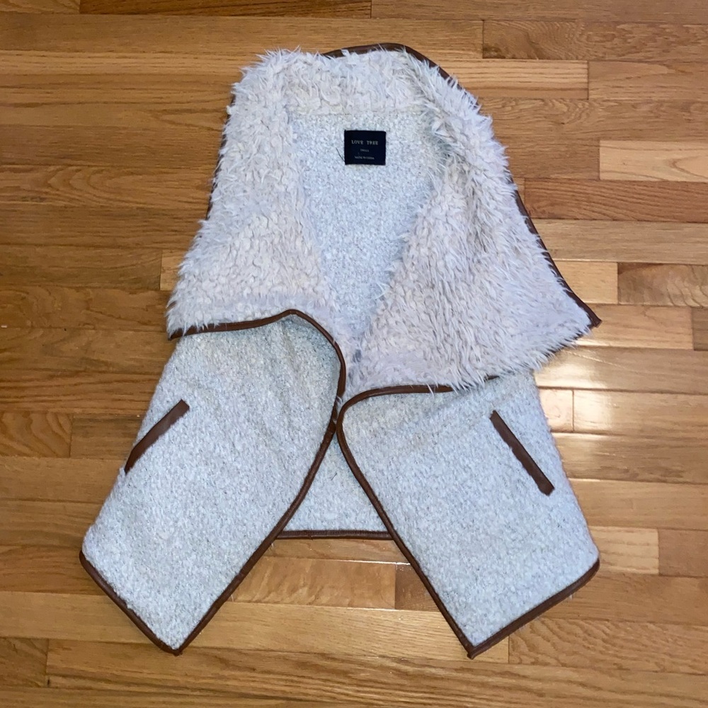 Tan faux fur vest with brown leather trim
